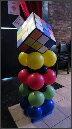 a rubik cube is stacked on top of balloons