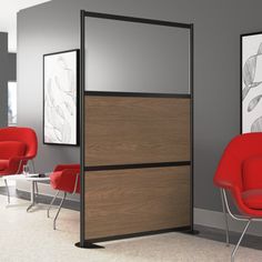 an office cubicle with two red chairs and a brown cabinet