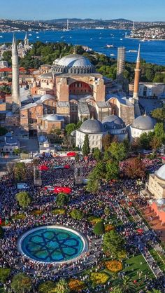 an aerial view of the blue mosque and its surrounding area, with many people gathered around it