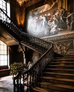 an ornate staircase with paintings on the wall