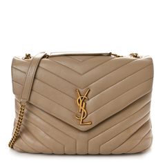 This is an authentic SAINT LAURENT Calfskin Y Quilted Monogram Medium Loulou Chain Satchel in Dark Beige. This shoulder tote features chevron quilted calfskin leather in beige. The bag has gold chain link shoulder straps with matching leather shoulder pads. The frontal flap features a prominent gold YSL monogram detail and opens to a partitioned black fabric interior with pockets. Chevron Quilt, Dark Beige, Shoulder Tote, Black Fabric, Shoulder Pads, Chain Link, Gold Chain, Shoulder Straps, Gold Chains