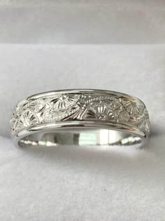 a wedding band with an intricate design on it