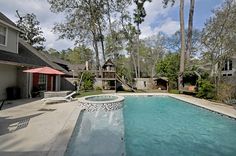 an empty swimming pool in front of a house