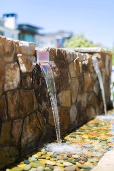 the water is running down the stone wall