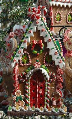 a gingerbread house decorated with candy canes and christmas decorations