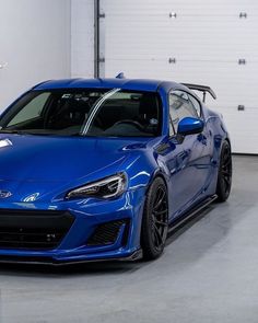 a blue sports car parked in a garage