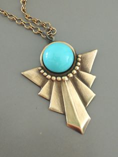 "Vintage Jewelry - Art Deco Necklace - Turquoise Necklace - Blue Necklace - Vintage Necklace - Chloe's Vintage handmade jewelry This is such a beautiful vintage necklace! An Art Deco design pendant embellished with a bright Turquoise glass cabochon. The pendant hangs from a pretty vintage brass ladder chain. Chloe says, \"Wear it and feel fabulous!\" This pendant is 1 3/4\" long. You can choose the length you would like at checkout. Thanks for visiting Chloe's" Turquoise Brass Necklaces For Jewelry Making, Blue Brass Jewelry For Jewelry Making, Artistic Blue Nickel-free Jewelry, Turquoise Brass Necklaces For Gift, Artisan Turquoise Brass Jewelry, Handmade Brass Art Deco Jewelry, Vintage Blue Jewelry With Unique Variations, Unique Turquoise Brass Necklaces, One Of A Kind Turquoise Brass Jewelry