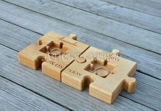 four pieces of wood with the names and date engraved on them, sitting on a wooden surface