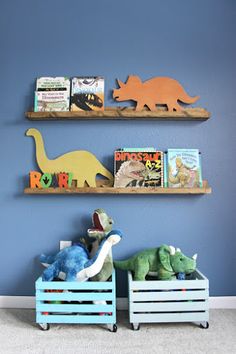 two wooden bookshelves with dinosaurs on them in front of a blue wall that says diy book ledges