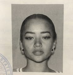 an old black and white photo of a woman's face with earrings on her head