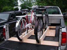 a bike is strapped to the back of a pickup truck with two bikes in it