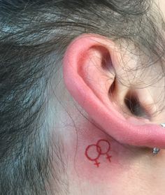 a person with a small tattoo on their ear