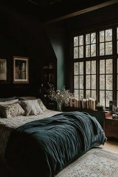 a large bed sitting in a bedroom next to a window with lots of windows on it