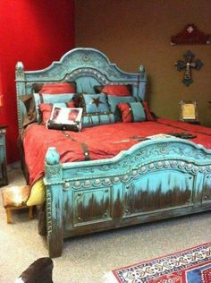 a bed room with a neatly made bed and red walls