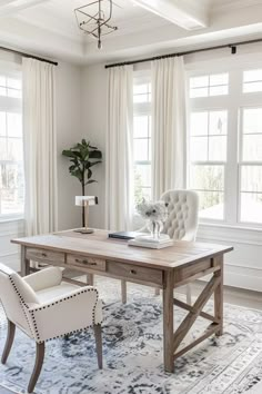 a desk with two chairs and a rug in front of it