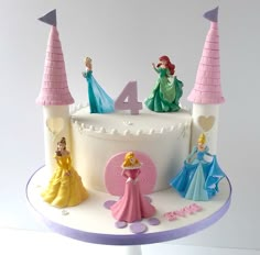 a birthday cake with princess figurines on top and the number four in front