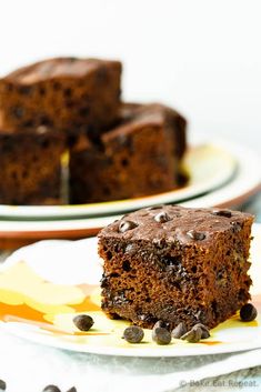 two plates with slices of chocolate cake on them