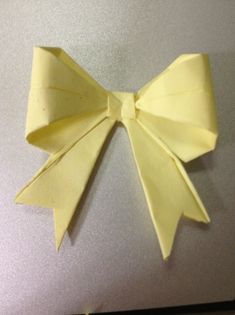 an origami bow sitting on top of a laptop computer