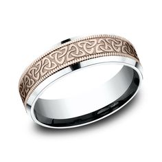 a wedding band that is in two tone gold and white gold with an intricate design