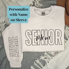 This beautiful Personalized Senior Mom Shirt would make an awesome Customized Senior Night shirt or a keepsake Gift for the Mom of a Class of 2025 high school or college graduate! ORDER IN 3 EASY STEPS: 1. Choose the color and size from the dropdown menu 2. Add custom text & Click 'add to cart' 3. Complete checkout and you're all set! PERSONALIZATION ▸ Please enter the name you would like on sleeve ▸ The front design will be automatically added. IMPORTANT NOTES ▸ Due to the nature of the fabric & printing process, as well as your monitor or mobile screen, colors may differ slightly ▸ Unisex Adult Sizing ▸ Rolled Sleeves in pictures is for styling purposes only ▸ Props used In photos are NOT included with purchase GILDAN BRAND SHIRTS ▸ Medium-heavy fabric blend of 50% cotton & 50% polyester Senior Mom 2025, Senior Mom Shirts, Senior Mom Shirt, Senior Shirts, Class Of 2025, College Graduate, Senior Graduation, Senior Night, Spirit Shirts