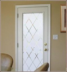 a white door with a glass window next to a chair