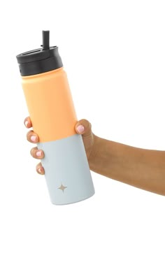 a person holding a coffee cup in their right hand and the other hand is holding it