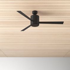 a ceiling fan mounted to the side of a wooden ceiling with black blades on it