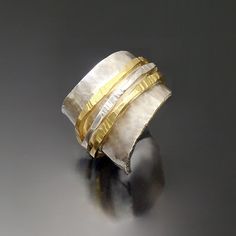 Gold & Silver Ring - A study in texture and contrast, this distinctive, hand-hammered ring pairs the cool shimmer of sterling silver with the warmth of 18k gold. Available in whole and half sizes 6 to 8.5. For pricing and availability of sizes outside of this range, please contact our customer care department.Care instructions. Polish with a silver polishing cloth. Unique Hammered Wide Band Rings, Ring Texture, Hammered Ring, Artful Home, Wide Rings, Customer Care, The Cool, Precious Metals, Silver Ring