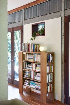 a bookshelf filled with lots of books in a living room