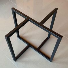 a black metal object sitting on top of a white tile floor