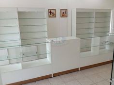 a room with glass shelves and pictures on the wall