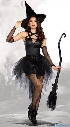 a woman dressed as a witch holding a broom and wearing a black dress with sheer stockings