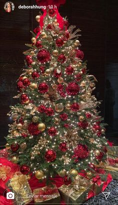 a christmas tree decorated with red and gold ornaments