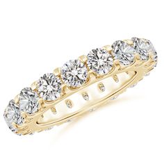 a yellow gold wedding band with five round cut diamonds on the sides and four prongs