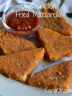 fried mozzarella on a white plate with sauce