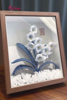 a glass case with some flowers in it