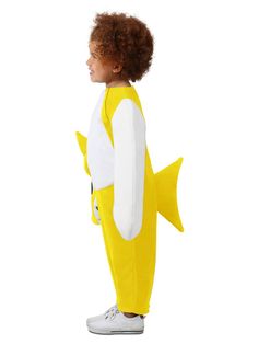 a little boy in a yellow and white shark costume is standing with his back to the camera