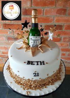 a birthday cake with a bottle of champagne on top