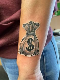 a woman with a tattoo on her arm holding a bag of money