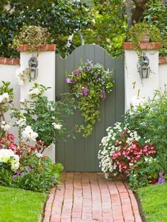 a garden gate with flowers growing on it