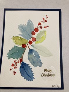 a christmas card with watercolor leaves and berries