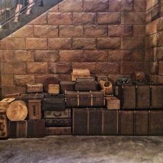 several pieces of luggage stacked on top of each other in front of a stair case