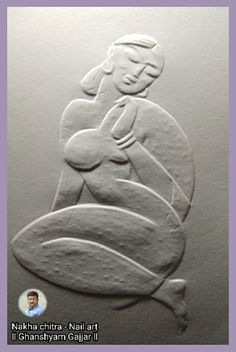 a carving of a woman holding a baby in her arms and sitting on a leaf