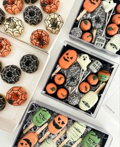 halloween cookies and cupcakes in boxes on a table