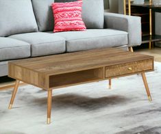 a living room with a gray couch and wooden coffee table in front of a grey sofa