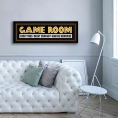 a room with a couch, table and lamp in it that says game room good times great company - making memories