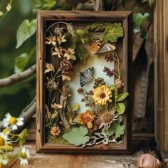 a wooden frame with flowers and butterflies in it