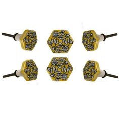 four yellow and black knobs with flowers on them