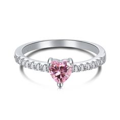 Everyone needs a heart ring in their collection and the Verona Ring is it! It's dainty and not overpowering so its perfect for stacking with other rings. The small pink heart gives it feminine vibes. The Band is encrusted with stones which elevate the ring. Wear this daily or on a night out. It will sparkle all day long. Material: Full Sterling Silver 925Center Stone: 5x5mmSizes: 5-10 Tarnish Free Hypoallergenic Glazd Pouch with every order Free US shipping Easy Exchange & Return policy PRODUCT Cupid Ring, Heart Solitaire Ring, Pink Heart Rings, Promise Jewelry, Pink Diamond Ring, Diamond Heart Ring, Pearl Jewelry Sets, Pink Gemstones, Pink Ring