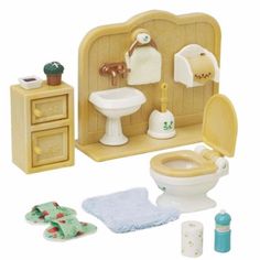 a dollhouse bathroom with toilet, sink and mirror